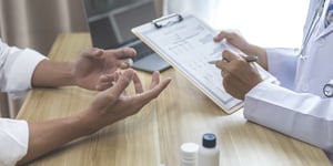 Medical- looking conversation with table as focal point - banner