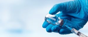 Gloved hand fills syringe banner size - stock image