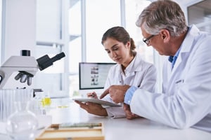 Woman and man in medical research working on technology for scientific research_602489238-min