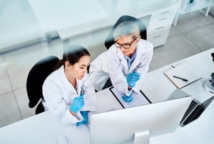 Women Looking at Computer in Lab - Stock Image-min