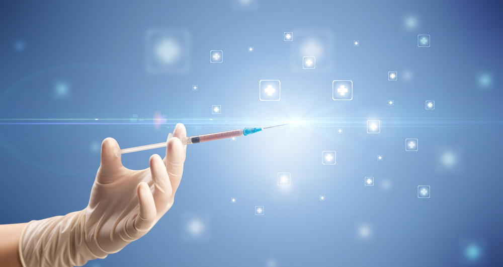 Female doctor hand holding syringe with shiny crosses in the background